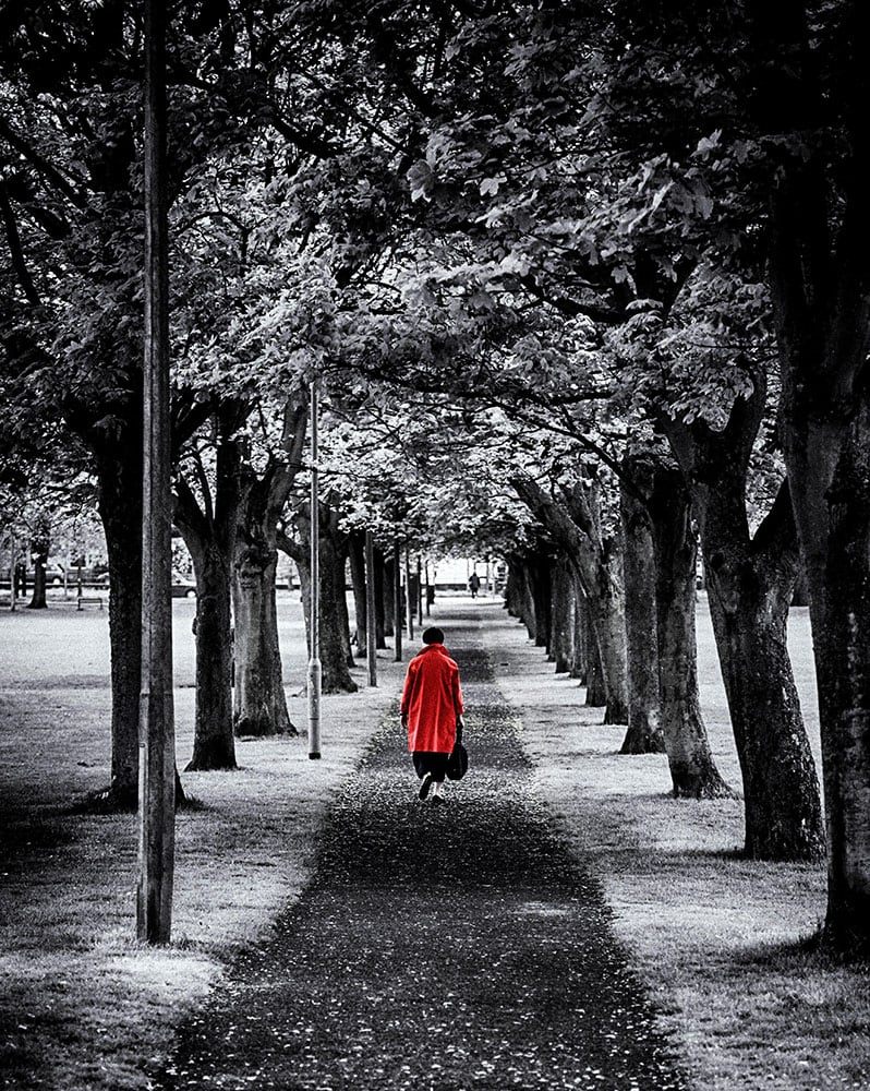 Woman in a Red Coat among Trees