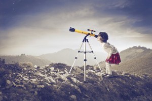 Girl Looking Through A Telescope